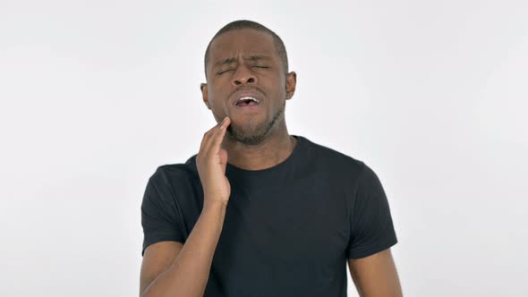 Young African Man with Toothache on White Background