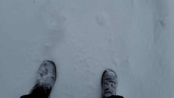 Two People are Walking Along on Snowly Road