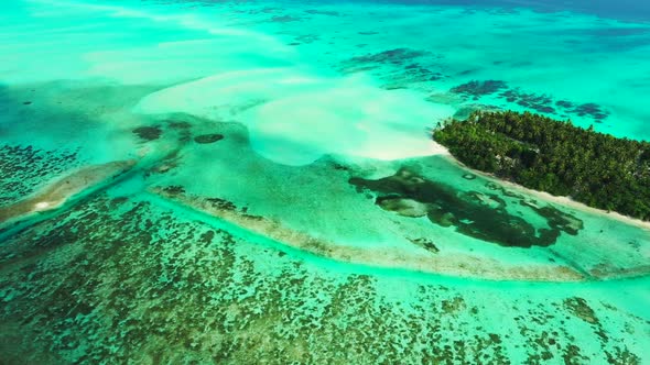 Aerial travel of tranquil sea view beach break by shallow ocean with white sand background of a dayt