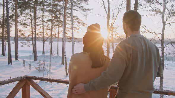 Couple Enjoying View From Front Porch of Cabin