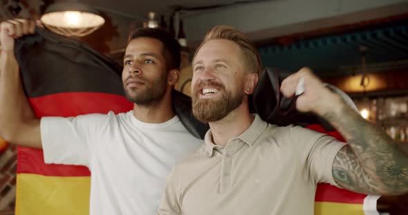 Soccer Fans Celebrating Victory of Team in Sports Bar