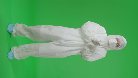 Full Body Of Asian Man Wear Protective Uniform PPE And Clapping His Hands In The Green Screen Studio