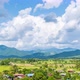 Rice paddy farming filed and village at Pua district Nan province, Thailand; zoom out - time lapse - VideoHive Item for Sale