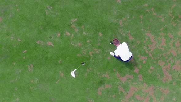 Top View of the Ball Rolling Past the Golf Hole