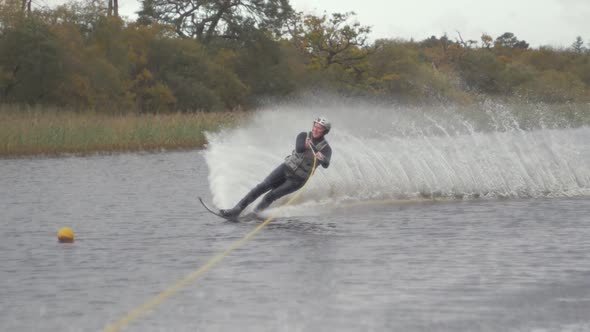 Slalom slow motion water ski cut around buoy