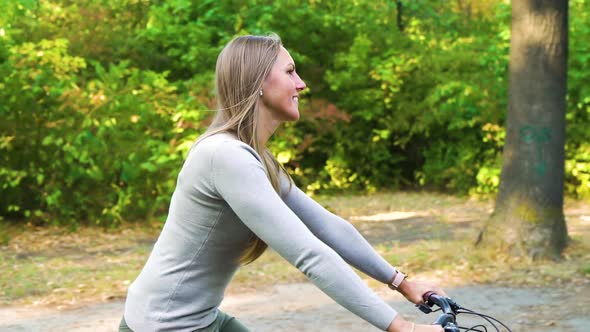 Woman on cycle ride with family in park