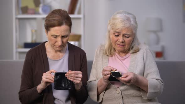 Sad Senior Female Friends Looking in Empty Wallets, Poor Budget, Low Incomes