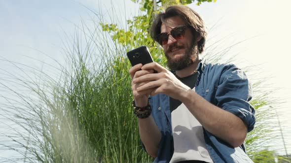 Man Uses Phone in Street