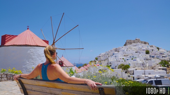 Young Woman Admiring the View of Astypalea Island from a Park Bench, Greece, Europe