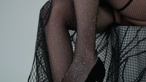 sexy woman legs in black fishnet tights