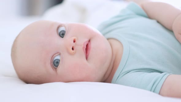 Funny Infant Face Portrait Blue Eyes Happy Smiling Baby Child 3 Months on White