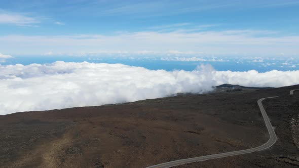 Heavenly Road Above the Clouds on Mountain Summit of Haleakala Volcano, Maui - Aerial