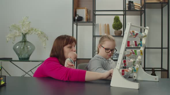 Caring Mom with Down Syndrome Kid Practicing Speech Therapy