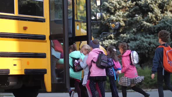 Diverse Joyful Pupils Hurrying To Enter School Bus