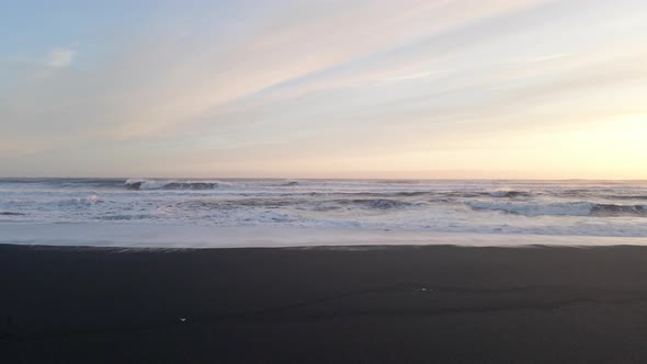 Drone Over Waves Towards Horizon At Sunset