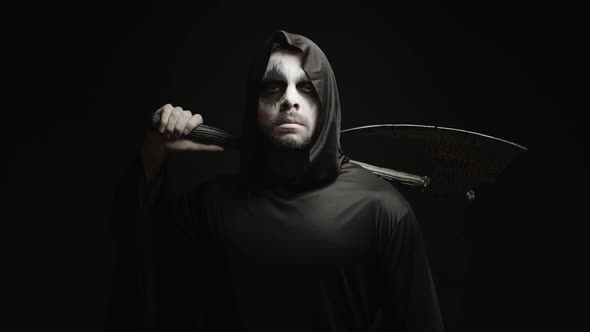 Grim Reaper Over Black Background with Axe in His Hands