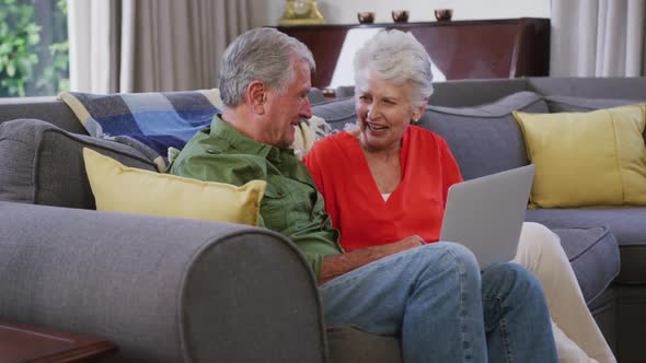 Senior Caucasian couple spending time and working together at home