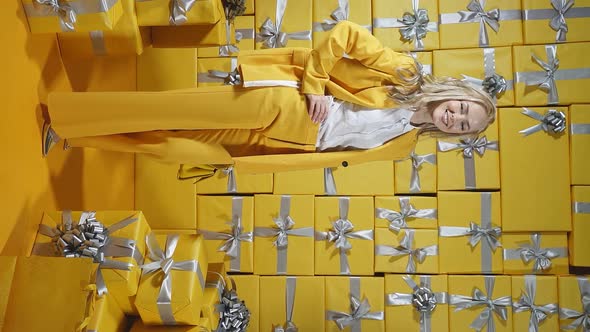 a Young Model in a Stylish Yellow Suit Poses in Front of the Camera in Full Growth Against an