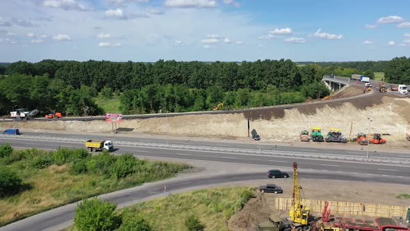 Asphalt road under construction. Aerial view aboveroad construction worker, view from drone