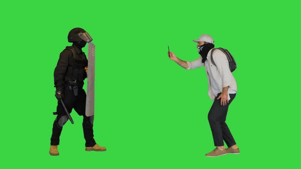 Aggressive Protester Shooting Riot Police on Smartphone on a Green Screen Chroma Key