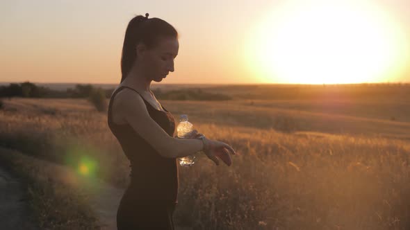 Young Woman Runner Looking at Sports Smart Watch, Checking Performance or Heart Rate Pulse Trace