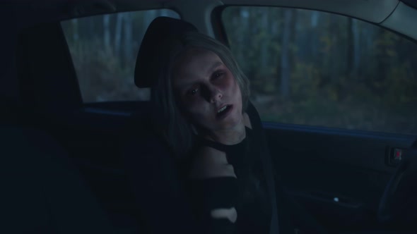 Zombie Woman in Car Attacking You Stretching Hand To Camera
