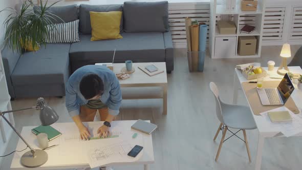 Time Lapse of Architect Working on Building Plan in Office