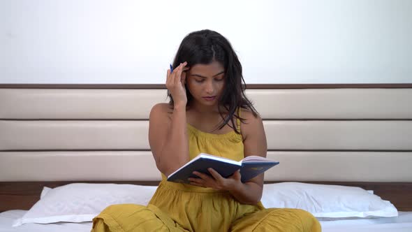 Annoyed Indian woman writing notes