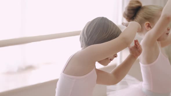 Little Girls Bending Together in Ballet Class