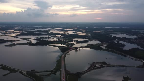 Aerial view asphalt road cross Kampar abandoned tin mining lake