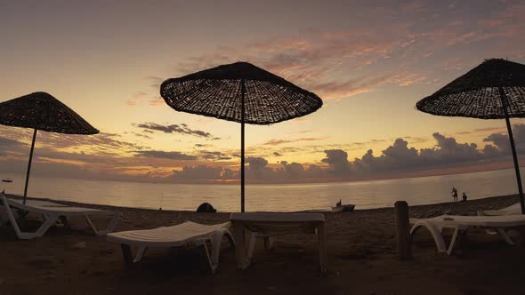 People and Beautiful Dawn on the Beach