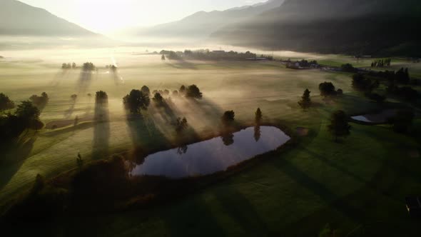 Drone Towards Sunrise Over Misty Landscape Of Zell Am See