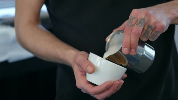 Barista Making Coffee, Pouring Milk Into a Cup