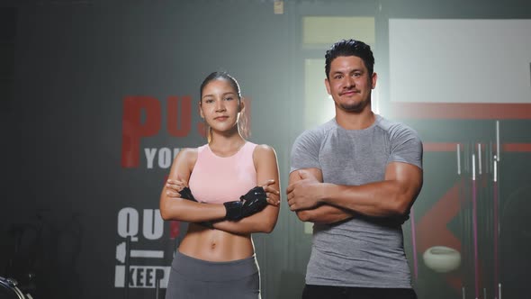 Portrait of Active Sport athlete man and woman with six pack abs in sportswear give high five.