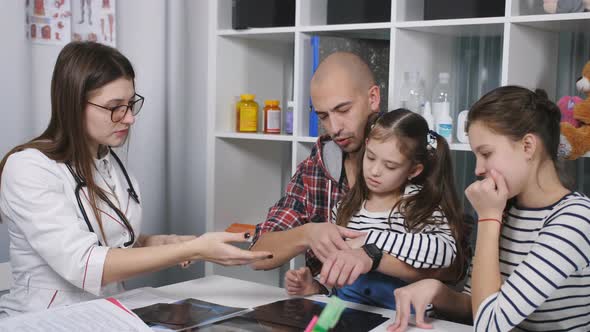 Father with Two Daughters on Consultation in the Office of the Family Doctor