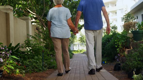 Senior couple walking in the garden