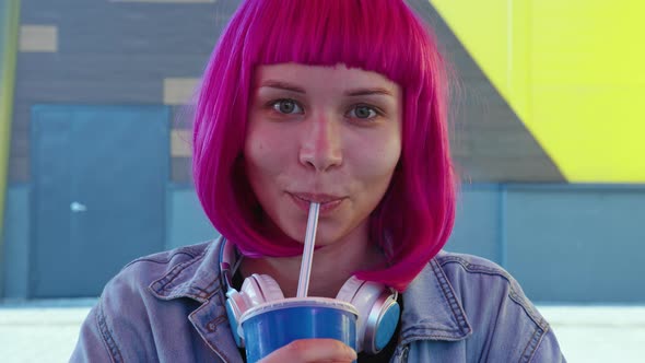 Girl with Pink Bob Haircut Drinks Beverage