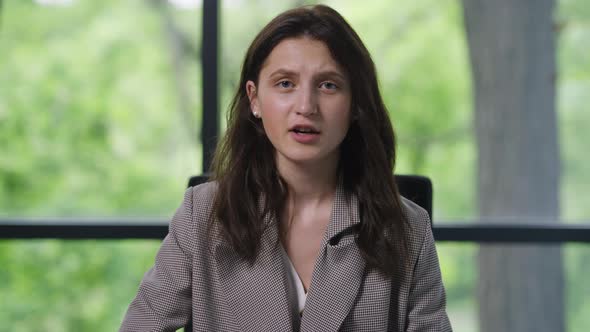 Portrait of Confident Woman Talking in Video Chat Looking at Camera