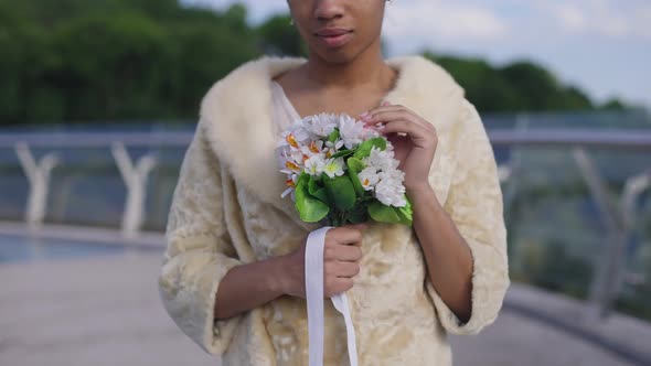 Unrecognizable Confident African American Bride in Wedding Dress Holding Beautiful Bridal Bouquet