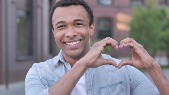 Handmade Heart by African Man Standing Outdoor