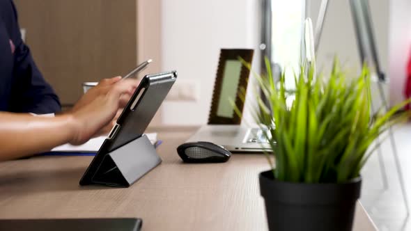 Woman Hands Touching a Digital Tablet Screen in the Office