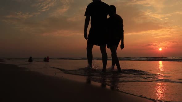 Father and Son on the Beach at Sunset