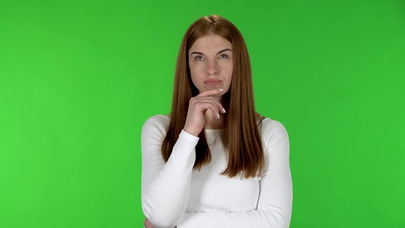 Portrait of Pretty Young Woman Is Focused Thinking About Something, No Idea