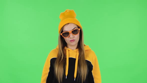 Portrait Frustrated Girl in Yellow Hat Is Taking Off Sunglasses and Saying Wow with Shocked Face