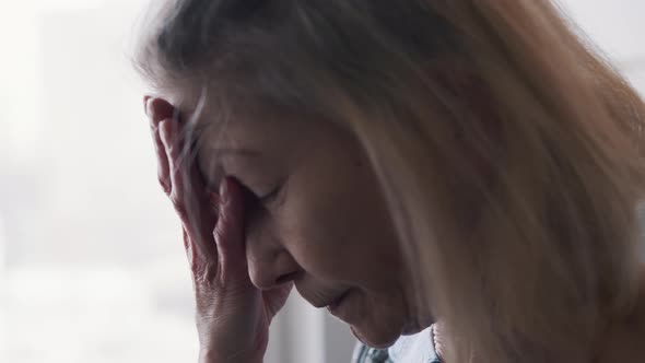 Old Lonely Woman Suffering From Headache