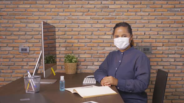 Portrait of ill African American business woman wearing a face mask. Black person working