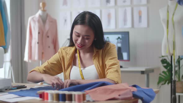 Asian Female Designer Creates A Template Of The Future Dress. She Draws A Chalk Outline