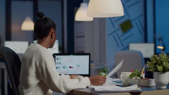 African Business Woman Holding Documents with Graphics