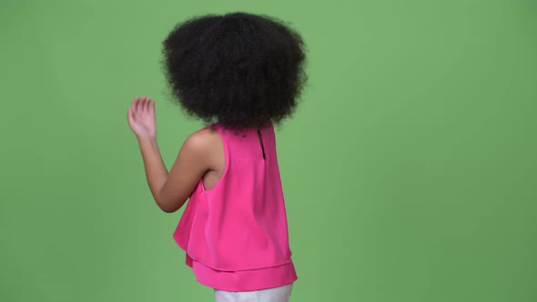 Young Cute African Girl with Afro Hair Showing Something