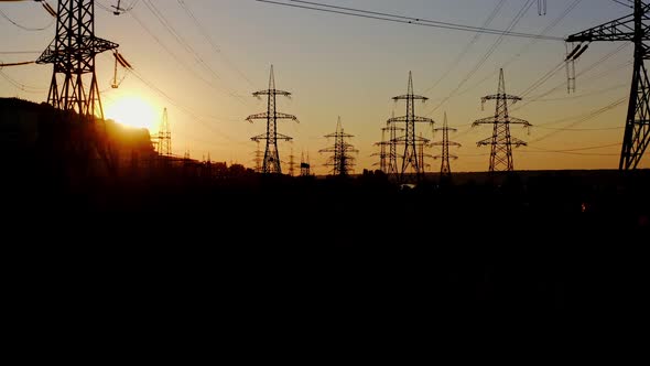 High voltage post at sunset. High voltage towers with electrical wires